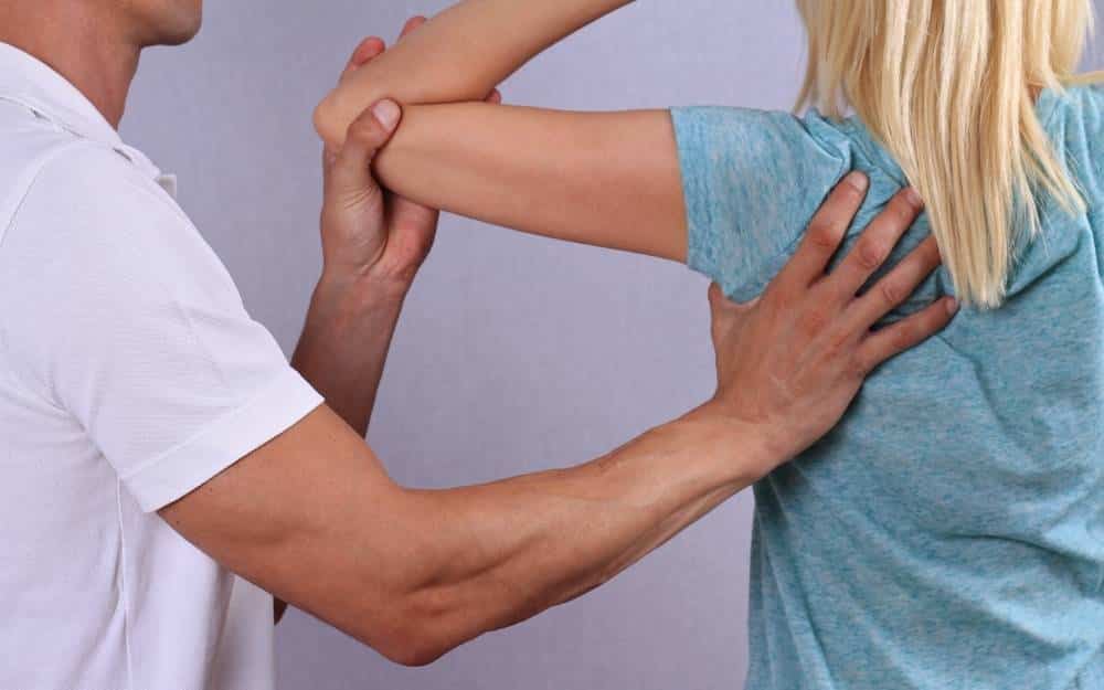 Physiotherapist performing manual therapy on a patient's shoulder