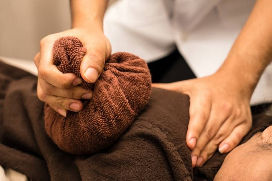 Reflexology massage on the sole of a patient's foot