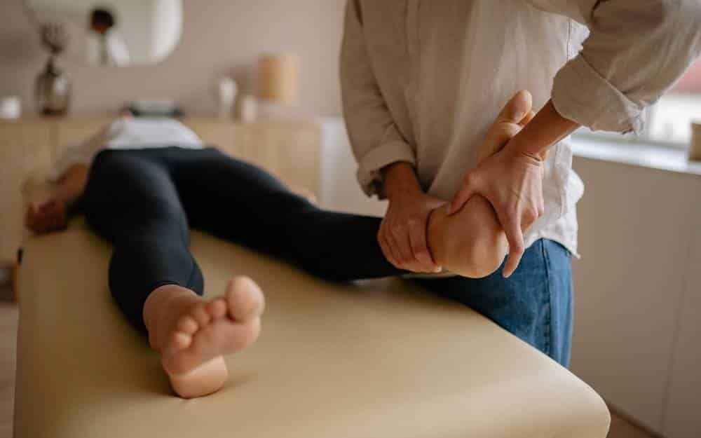Therapist giving a reflexology foot treatment