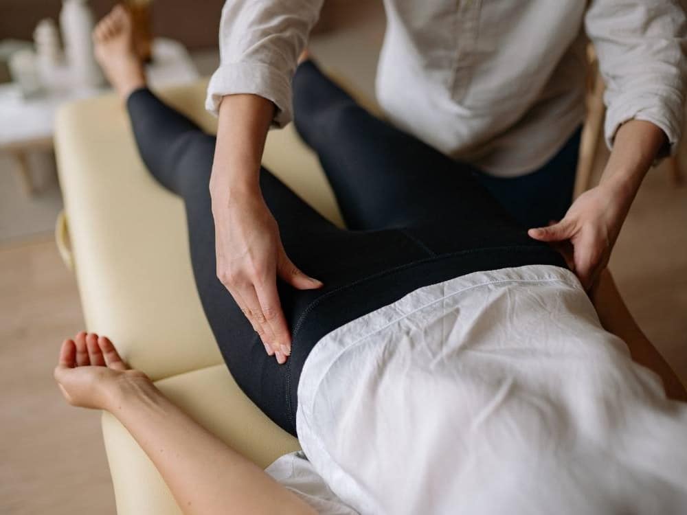 Therapist treating a patient's hip and glute muscles