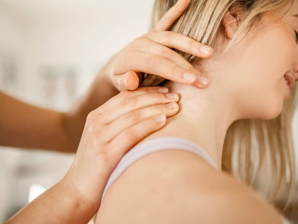 Therapist treating a patient's neck and upper shoulders