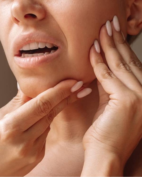 Therapist treating a patient's jaw for TMJ pain